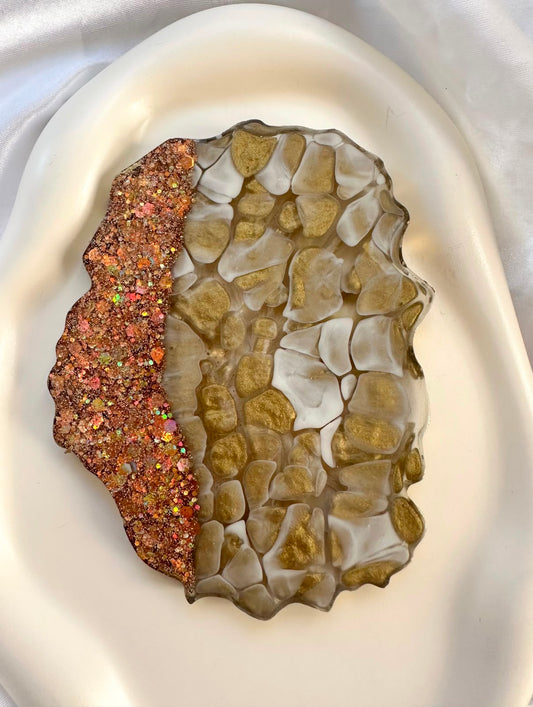 Irregular mosaic-style coaster with pale pieces and copper-toned glitter edge