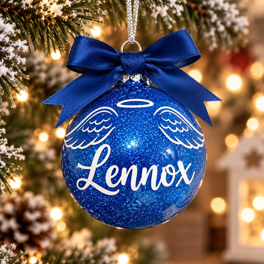 Blue personalised memorial Christmas bauble with angel wings, halo, name Lennox and matching ribbon on a tree